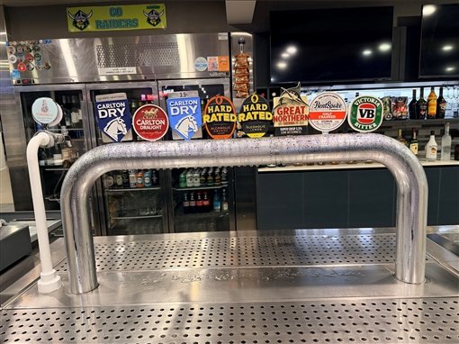 The VicBar taps, with Carlton Dry, Carlton Draught, Great Northern and VB, under a Go Raiders sign